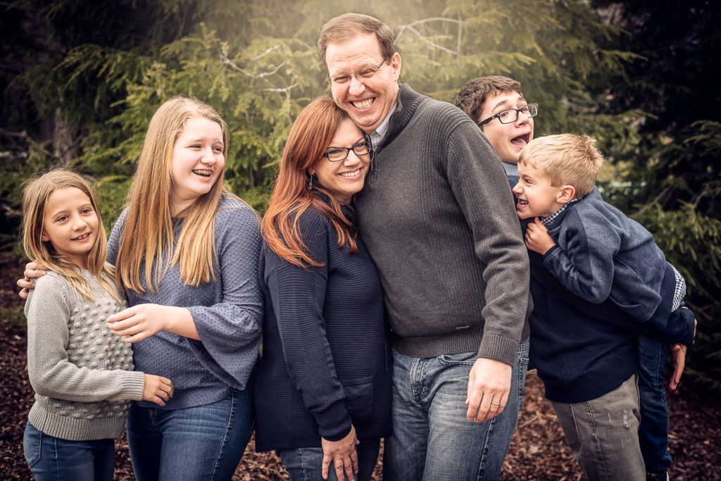family laughing and having fun during photo shoot
