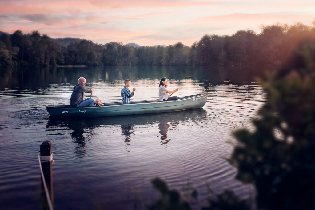 family canoeing on Biltmore Lake in North carolina.