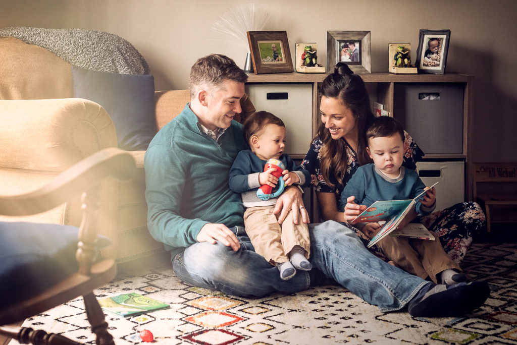 parents enjoying their toddlers during photo shoot by choosing a family photographer