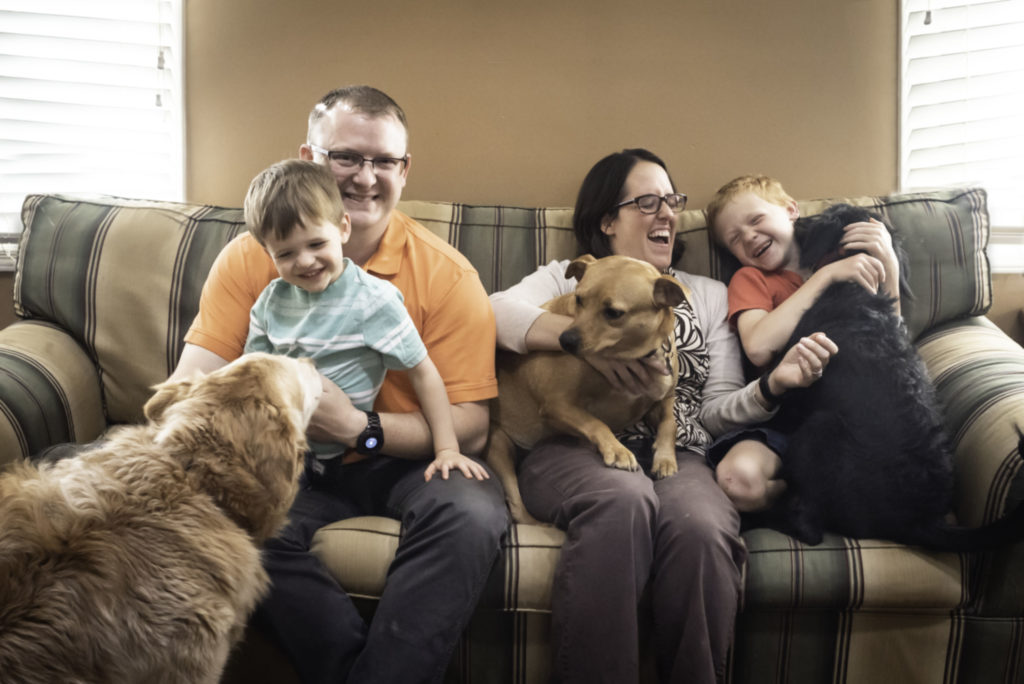 family playing with pets